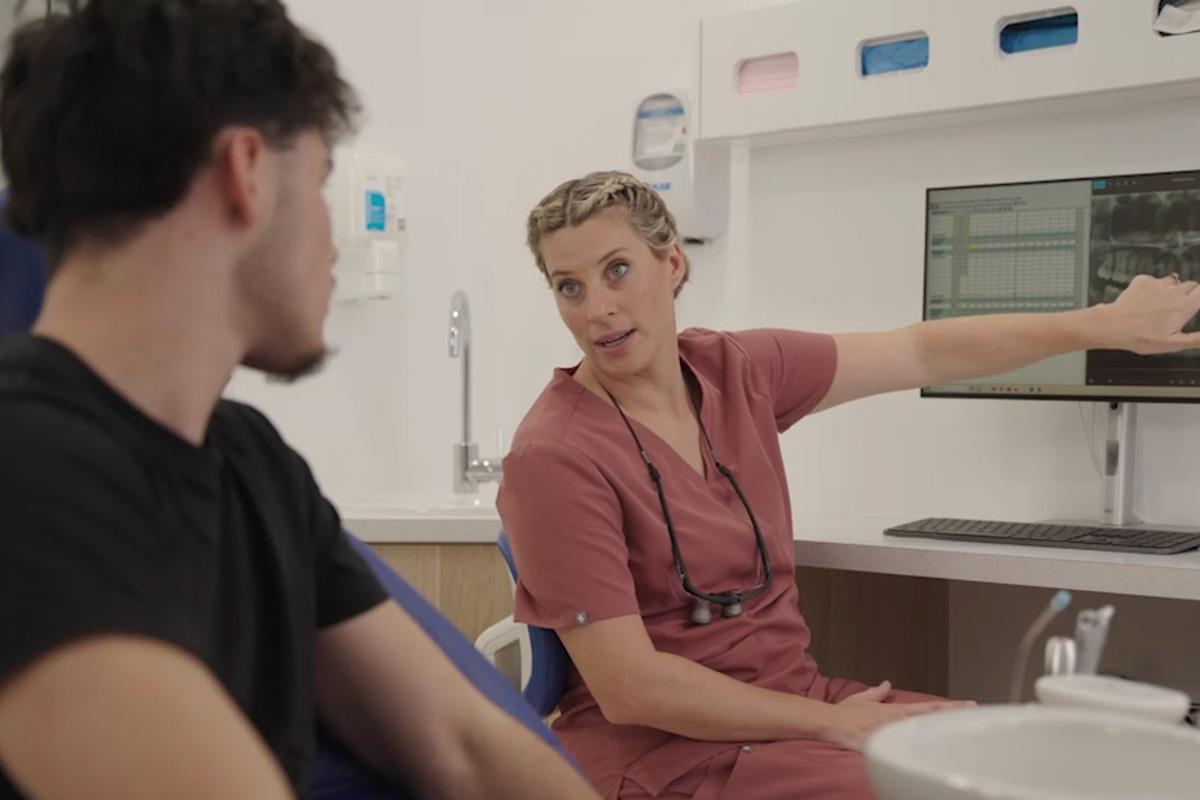 dental hygienist looking at xray