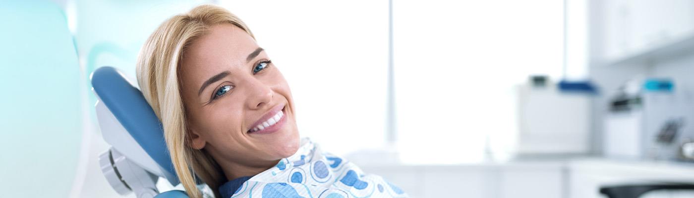 dental hygienist looking in patient mouth